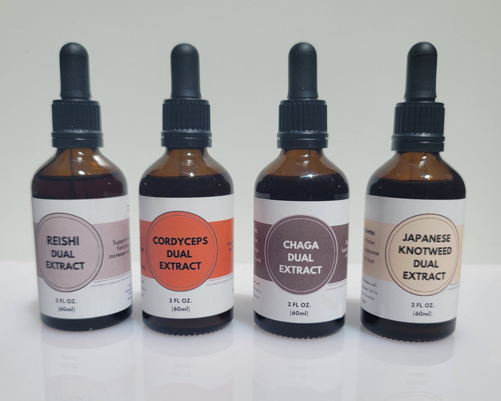 Four bottles of dual extract on a white background
